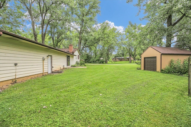 1106 Riverside Ct, Mahomet, IL 61853 - view of grassy yard featuring an outdoor structure and a detached garage