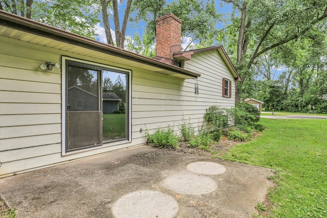 1106 Riverside Ct, Mahomet, IL 61853 - view of side of property featuring a patio, a chimney, and a lawn