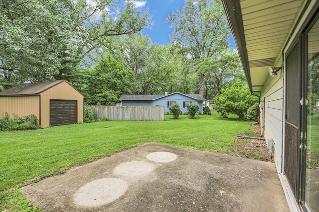 1106 Riverside Ct, Mahomet, IL 61853 - view of yard with an outdoor structure, a garage, a patio area, and view of wooded area