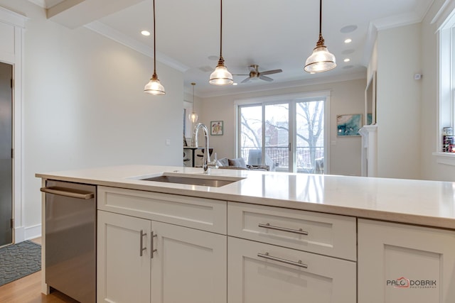 kitchen with crown molding, a ceiling fan, a sink, and light countertops
