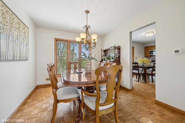 965 Sycamore Ct, Hoffman Estates, IL 60192 - dining space featuring baseboards and a chandelier
