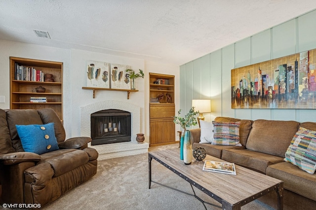 965 Sycamore Ct, Hoffman Estates, IL 60192 - carpeted living room featuring built in features, a textured ceiling, and a brick fireplace