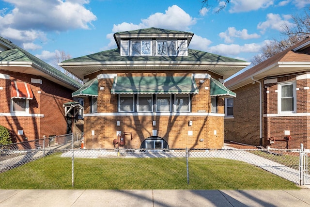 view of front of property with a fenced front yard, a front lawn, and brick siding