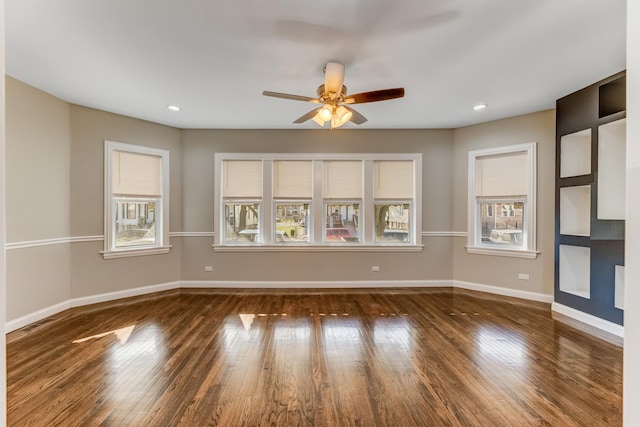 empty room with baseboards, ceiling fan, recessed lighting, and wood finished floors