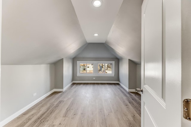 bonus room featuring recessed lighting, baseboards, vaulted ceiling, and wood finished floors