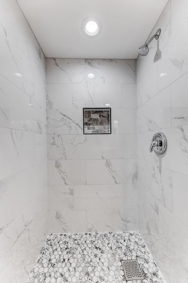 bathroom with tiled shower