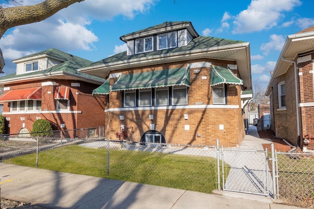 view of front facade with a gate, fence private yard, brick siding, and a front yard