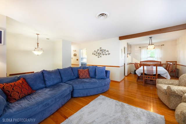 living room featuring wood finished floors and visible vents