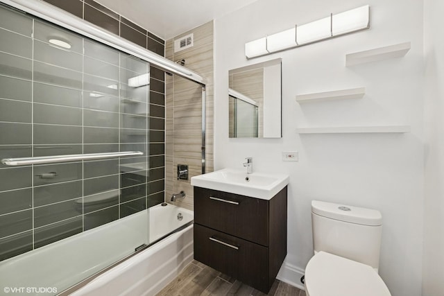 1460 N Sandburg Ter Unit 2608A, Chicago, IL 60610 - bathroom with vanity, toilet, combined bath / shower with glass door, wood finished floors, and visible vents