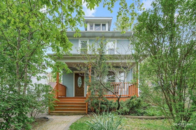 american foursquare style home featuring covered porch