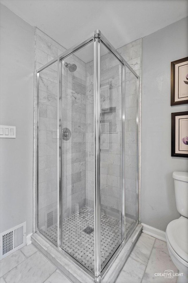 bathroom with visible vents, toilet, and a shower stall