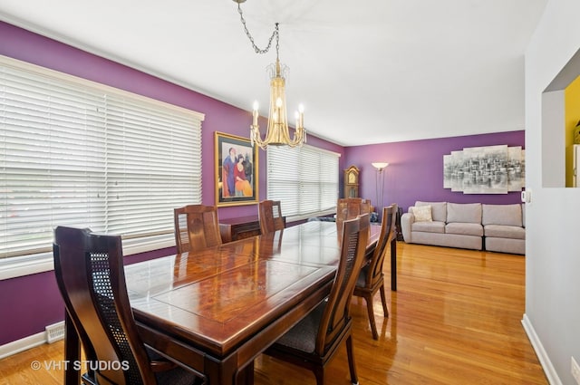 9336 Lavergne Ave, Skokie, IL 60077 - dining area with a chandelier, baseboards, and wood finished floors