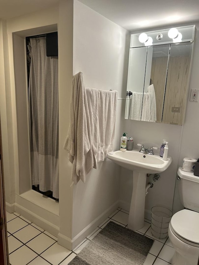 1828 N 21st Ave, Melrose Park, IL 60160 - bathroom with toilet, tile patterned floors, and a shower stall
