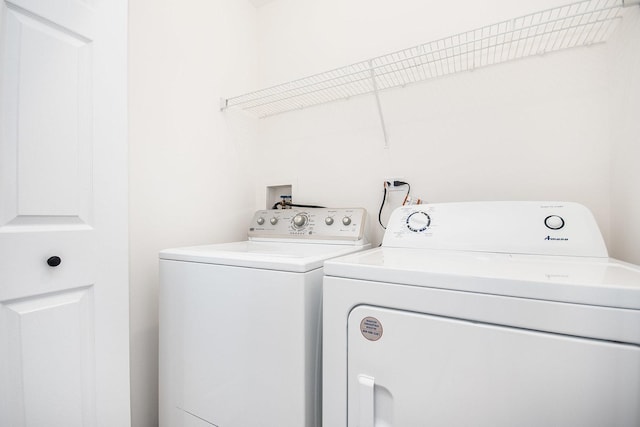 washroom featuring washing machine and clothes dryer and laundry area