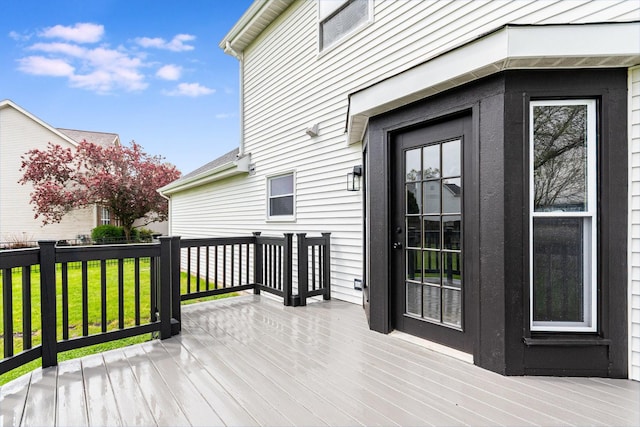 wooden deck featuring a lawn