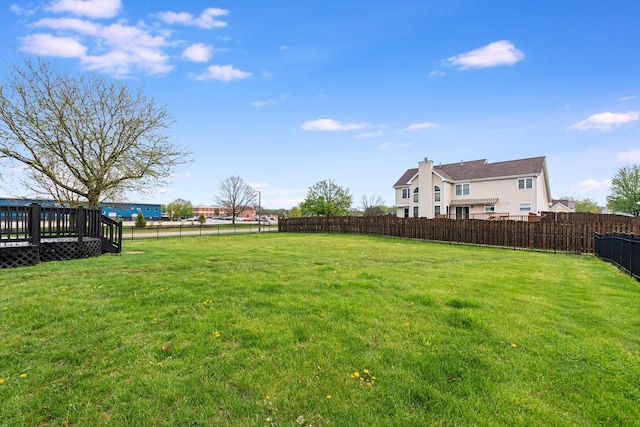 view of yard with fence and a deck
