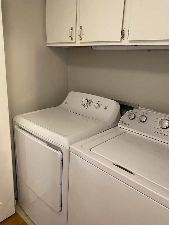 washroom with cabinet space and independent washer and dryer