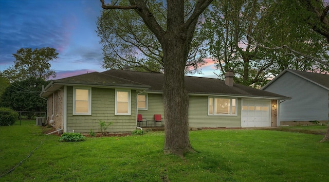 307 Dodson Dr W, Urbana, IL 61802 - view of front of home featuring a garage, a front yard, a chimney, and central AC unit