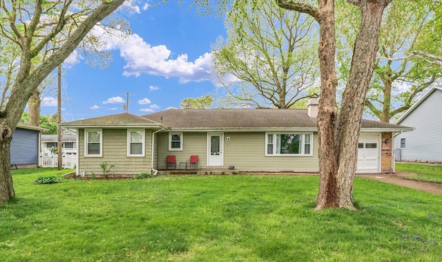 307 Dodson Dr W, Urbana, IL 61802 - ranch-style house with roof with shingles, a chimney, an attached garage, and a front lawn