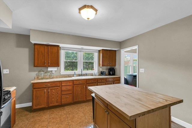 307 Dodson Dr W, Urbana, IL 61802 - kitchen with a sink, butcher block counters, brown cabinets, and stainless steel gas range oven