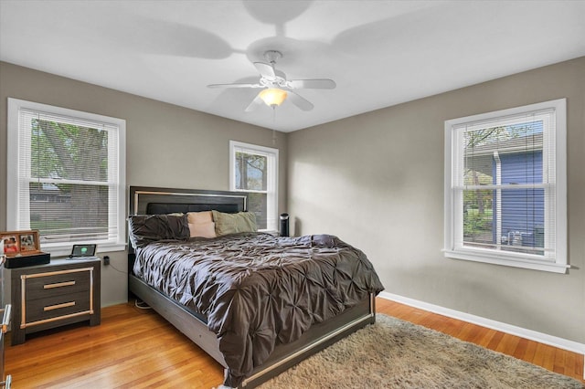 307 Dodson Dr W, Urbana, IL 61802 - bedroom with baseboards, multiple windows, ceiling fan, and light wood-style floors
