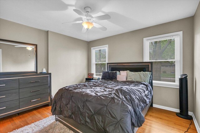 307 Dodson Dr W, Urbana, IL 61802 - bedroom with baseboards, ceiling fan, and light wood-type flooring