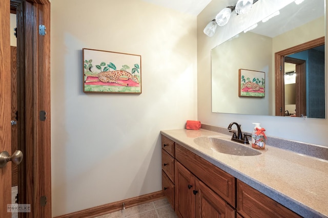 bathroom with baseboards, tile patterned floors, and vanity