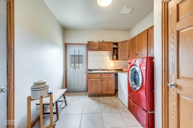 laundry room with a sink, cabinet space, independent washer and dryer, and light tile patterned flooring