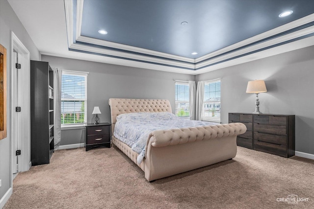 bedroom with a raised ceiling, baseboards, recessed lighting, and light colored carpet