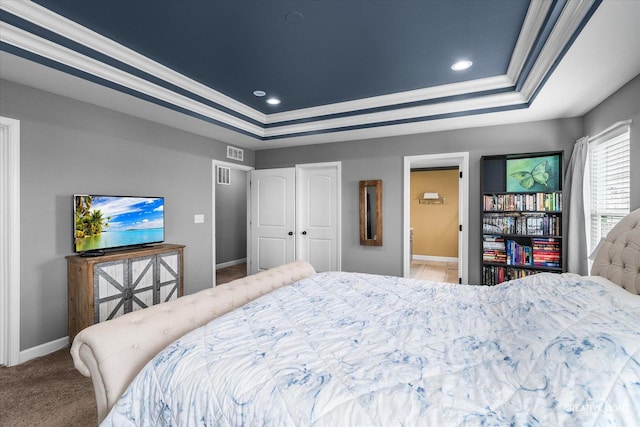 bedroom with crown molding, carpet flooring, baseboards, and a tray ceiling