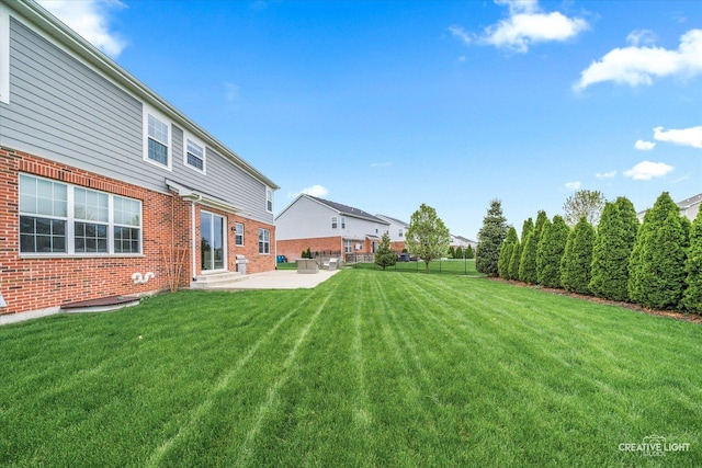 view of yard with fence, entry steps, and a patio area