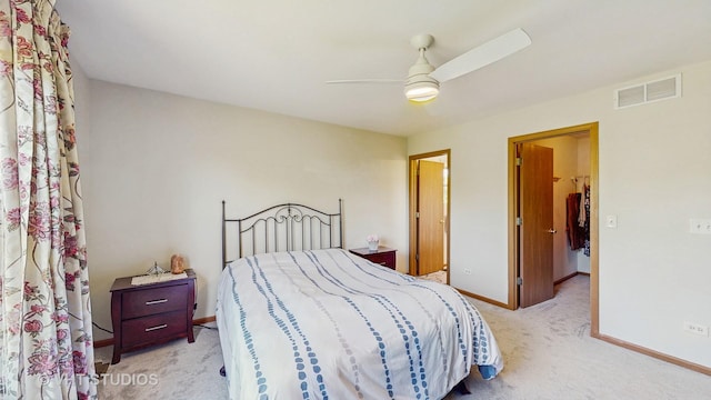 bedroom with light colored carpet, baseboards, and a ceiling fan