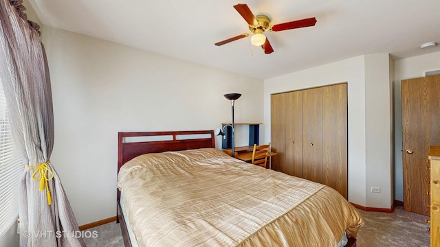 bedroom with carpet floors, a closet, baseboards, and ceiling fan