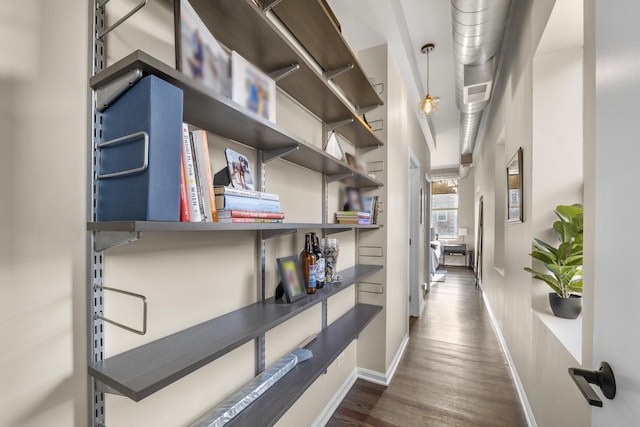 hall with wood finished floors and baseboards