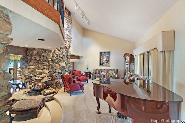 carpeted dining room featuring high vaulted ceiling and a fireplace
