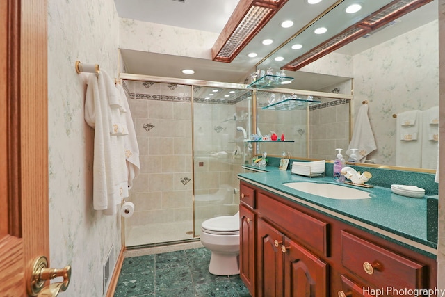 bathroom featuring recessed lighting, wallpapered walls, a shower stall, toilet, and vanity