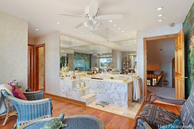 full bathroom with a ceiling fan, hardwood / wood-style flooring, a garden tub, and recessed lighting