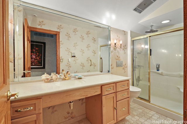 bathroom featuring a shower stall, vanity, toilet, and wallpapered walls