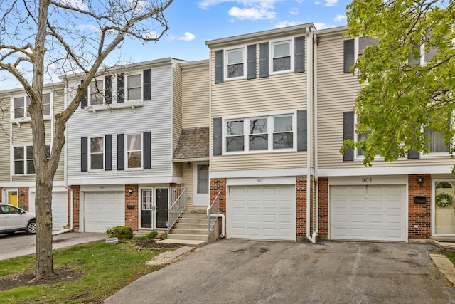 907 Banbury Ct, Schaumburg, IL 60194 - multi unit property featuring an attached garage, brick siding, and driveway