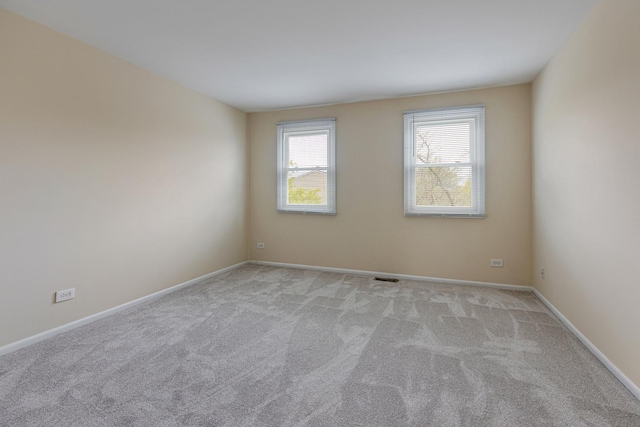 907 Banbury Ct, Schaumburg, IL 60194 - spare room with light carpet, baseboards, and visible vents