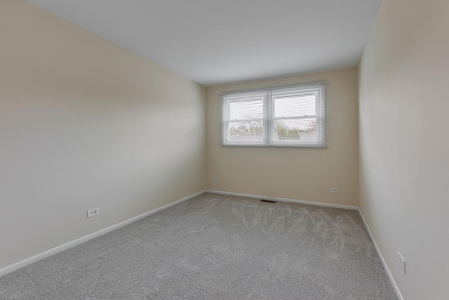 907 Banbury Ct, Schaumburg, IL 60194 - empty room with baseboards, visible vents, and light colored carpet
