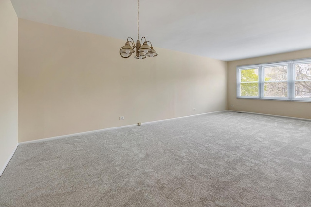 907 Banbury Ct, Schaumburg, IL 60194 - empty room with carpet flooring, baseboards, and a notable chandelier