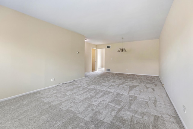907 Banbury Ct, Schaumburg, IL 60194 - spare room featuring light colored carpet, a notable chandelier, baseboards, and visible vents
