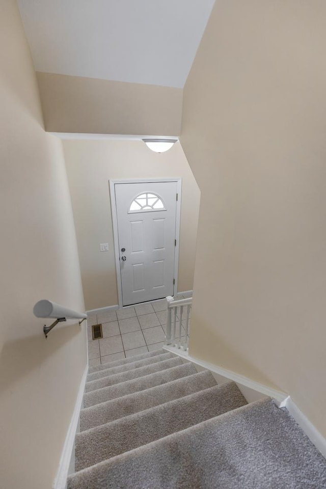 907 Banbury Ct, Schaumburg, IL 60194 - staircase with baseboards, carpet flooring, tile patterned floors, and vaulted ceiling