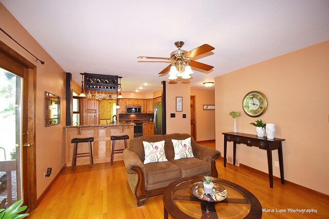 5N850 Ravine Dr, Saint Charles, IL 60175 - living room with light wood-style flooring, ceiling fan, and baseboards