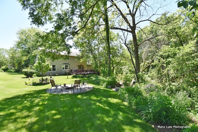5N850 Ravine Dr, Saint Charles, IL 60175 - view of grassy yard featuring a patio area, a deck, and an outdoor fire pit