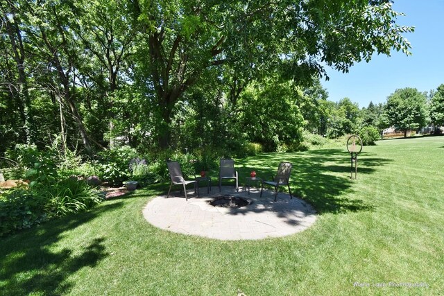 5N850 Ravine Dr, Saint Charles, IL 60175 - view of green lawn featuring a patio area and an outdoor fire pit