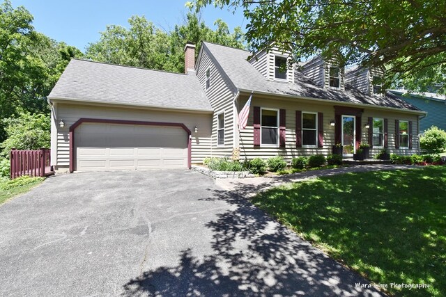 5N850 Ravine Dr, Saint Charles, IL 60175 - cape cod home featuring driveway, an attached garage, a front lawn, and a chimney