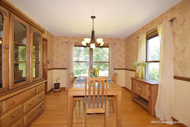 5N850 Ravine Dr, Saint Charles, IL 60175 - dining room with wallpapered walls, a chandelier, light wood-style floors, baseboards, and wainscoting