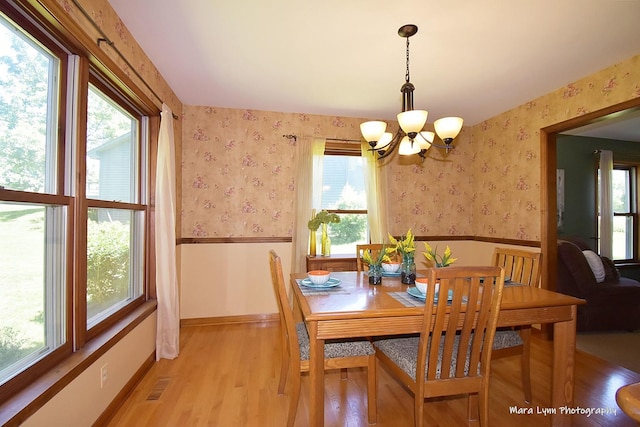 5N850 Ravine Dr, Saint Charles, IL 60175 - dining space with a chandelier, wallpapered walls, wainscoting, light wood finished floors, and healthy amount of natural light